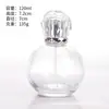Venta al por mayor de botellas de perfume de vidrio transparente con formas únicas, botellas cilíndricas triangulares con base volcánica, botellas para sueros de cuidado de la piel y botellas con atomizador