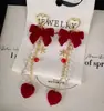 Brincos de meteoros rotativos Outono e inverno Ano Novo Brincos de laço vermelho Design de nicho doce Sense Ear Clip Mulheres
