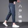 Jeans elásticos de 8/9 de largo para hombre Guangzhou Xintang, modernos y versátiles para primavera y otoño, de moda para personas bajas de 160 cm