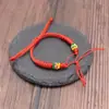 Estilo simple nudo kong king cuerda de mano producto semiacabado pulsera tejida hombres y mujeres año de nacimiento cuerda roja pareja puede usar cuentas hebilla de paz