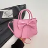 Bolso transfronterizo para mujer, suave, moderno, bolso de mano con lazo simple, nuevo modelo 2026, color liso estilo coreano, bolso de hombro y cruzado para mujer