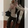 Top de punto extremadamente elegante con cuello en V y corte ajustado para mujer, nuevo suéter de manga larga para otoño 2025, top atmosférico