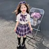 Conjunto de Uniforme JK para Meninas 2026 Chegada Nova de Verão Estilo Escolar Infantil Elegante Saia Plissada Xadrez Conjunto de Duas Peças Camisa