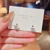 Pendientes coreanos de lujo ligero de nicho retro con lazo para mujer, minimalistas y compactos, con un diseño único y estilo versátil