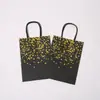 Suministro transfronterizo en stock de fábrica bolsa de papel portátil con estampado negro bolsa de cartón negro bolsa de regalo con cuerda de papel