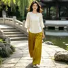 Conjunto de top de seda de estilo chino otoñal, con reducción de edad y calidad garantizada, con tapeta diagonal y detalles de botones, combinado con pantalones de pierna ancha para mujeres de mediana edad