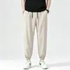 Fábrica de comercio exterior selecciona cuidadosamente pantalones jogger de seda helada, pantalones deportivos casuales de verano finos de secado rápido, pantalones de nueve puntos holgados para hombre