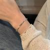 Pulsera coreana de acero de titanio con circonita super flash para mujer, pulsera de temperamento de lujo ligero de alta gama, celebridad de internet, simple, versátil, accesorios de mano al por mayor