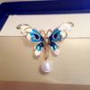 Broche de mariposa tridimensional con goteo de aceite de color nuevo transfronterizo europeo y americano para mujer, hebilla de alfiler de perla, accesorios de temperamento anti-exposición
