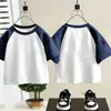 Camiseta Color Block de Manga Curta 100% Algodão para Crianças 2026 Verão Unissex Versátil Tendência Color Block Raglan Manga Meia Manga Camada Base Tendência