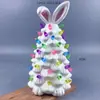 Árvore de Natal de cerâmica em forma de coelho azul claro com lâmpadas coloridas, decoração festiva brilhante para a Páscoa na Europa e na América