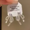 Pendientes de Encaje con Lazo y Corazón de Zirconia Aguja Plateada Lujo Ligero Moda Coreana Estilo de Alta Gama Pendientes de Personalidad de Nicho