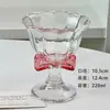 Taza alta con lazo rosa, copa de vino tinto de alto valor, copa de champán, copa de cóctel, taza de café