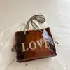 2026 Nova Tendência Estilo Coreano Versátil Elegante Bolsa de Praia Grande Capacidade Transparente Gelatina Bolsa Tote de Ombro para Mulheres