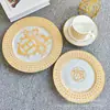 Plato de cena occidental de porcelana de hueso con borde dorado estilo europeo transfronterizo, decoración para sala de modelos, mesa de sala, plato plano de cerámica para el hogar