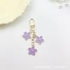 Llavero con forma de flor de gota de aceite de color transfronterizo de Europa y Estados Unidos, personalidad creativa, lindo bolso colgante con juego de auriculares