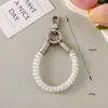 Estilo Ins Corda de telefone floral elástica curta Alça de pulso para celular Pingente versátil para bolsa Corrente de telefone anti-perda Pingente fofo