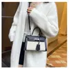 Bolsos estilo nuevo candado bolso Kelly, bolso de mano de moda europeo y americano con bloques de color para mujer, bolso cruzado de hombro texturizado y empalmado