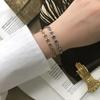 SL069 Pulseira estilo francês INS europeia e americana oval nariz de porco grão de café simples aço titânio banhado a ouro 18K proteção de cor