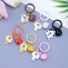 Clip de resorte Campanita Llavero de Gato Dibujo animado lindo Gato Donut Mochila Funda para auriculares Colgante de moda versátil