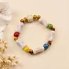 Pulsera de Cerámica Cocida en Horno Estilo Chino Nuevo de Jingdezhen con Incrustaciones de Madera Natural, Borlas de Plata Vintage, Estilo Nacional de Nicho, Exhibición de Puesto Estudiantil