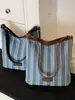 Bolsa de moda listrada de grande capacidade para mulheres 2026 nova bolsa tote de ombro casual moda executiva bolsa de balde tendência