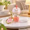 Llavero creativo de taza de té con leche líquida con accesorios de vida marina flotante, regalo colgante para mochila de estudiante y coche