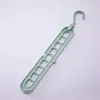 Colgador de ropa multifuncional de nueve agujeros para almacenamiento en el hogar, soporte para armario, popular colgador mágico giratorio retráctil plegable de nueve agujeros