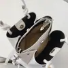 Bolsa de ombro e transversal popular de nicho transfronteiriça, bolsa saco de couro PU macio com padrão de lichia, bolsa de mão elegante e simples para mulheres