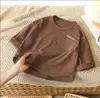 Top de Color Sólido Estilo Coreano para Niños Nuevo Modelo Primavera 2025 Simple Holgado de Manga Larga Térmico para Niños y Niñas