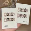 Um par de pontas de unha Gu [Jasmim Branco Dourado] cor marrom escuro Maillard e dourado estilo gatinho com delicados detalhes em rosa e dourado, feito à mão
