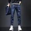 Jeans Suaves Forrados de Polar para Primavera y Otoño con Elasticidad Regular para Hombres Jóvenes, Estilo Coreano, Venta al por Mayor de Bajo Costo, Pantalones de Algodón Mercerizado de Corte Ajustado al por Mayor