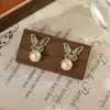 Collar de mariposa de perlas en capas estilo francés vintage, collar ajustable para mujer, pendientes de borla de nicho de lujo ligero y accesorios