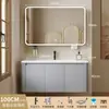 Tocador de baño engrosado y ahorrador de espacio con diseño en color crema, que cuenta con un lavabo redondeado, lavabo cerámico integrado y un lavabo de una sola pieza.