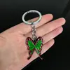 Llavero colgante de aleación de metal con diseño de mariposa Zhilang You Bean de Anime Ghost Extermination Blade que rodea el carbón. Comercio exterior.