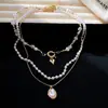 Collar de perlas vintage multicapa estilo francés para mujer, nicho de lujo ligero con un toque de alta gama, cadena para la clavícula, joyería para el cuello transfronteriza europea y americana para mujeres