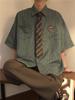 Camisa de rayas retro de estilo americano para hombre, de manga corta, para primavera y otoño, de alta gama, holgada, de marca y de moda.