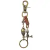 Llavero de cuero estilo punk europeo y americano con calavera, espada cruzada, colgante de dos tonos bronce antiguo y plata antigua con efecto envejecido para Amazon transfronterizo