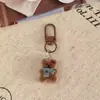 Nueva colección otoño/invierno: Llaveros de oso flocado retro, dijes lindos para mochila, perfectos como regalos para novias o parejas, disponibles al por mayor