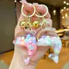 Nuevo llavero de muñeca de delfín con arena movediza relleno de aceite, colgante para mochila, decoración para bolso de pareja, regalo pequeño para venta al por mayor
