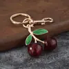 Acessório de liga metálica tipo fruta cereja translúcido com lantejoulas grandes dupla face Pingente de chaveiro DIY para bolsas de meninas