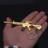Colgante modelo de pollo oro M4 arma de fuego modelo colgante de supervivencia llavero juego de pollos periférico 12cm