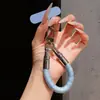 Correa de anillo superestilosa con bloques de color, duradera y resistente con un gancho de metal, un cordón para teléfono anti-pérdida para mujer para ir de compras