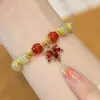 Pulseira de Galhos Dourados e Folhas de Jade Estilo Ins Design de Nicho Pulseira de Temperamento de Alto Senso para Mulheres Tom de Vibração com Joias de Mão Atacado