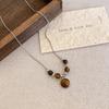 Collar de cuero estilo Maillard con ojo de tigre para mujer, gargantilla sencilla con cadena de lana, accesorios de nicho de alta calidad.