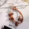 Cadena de Teléfono Móvil de Gama Alta de Nicho Pulsera de Muñeca con Perlas Bola de Pelo Estampado de Leopardo Marrón Retro Cadena de Pulsera Elegante
