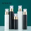 Venta al por mayor de fábrica en stock botella vacía de vidrio para cosméticos, emulsión, blanco mate, negro mate, con pulverizador de presión, solución de esencia de stock