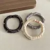Goma para el cabello de alta gama estilo coreano, de satén de cristal, color sólido, versátil y elegante para peinados de moño o cola de caballo