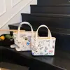 Bolso Bandolera de Hombro Único con Diseño de Nicho de Moda para Mujer 2026 Nuevo Estampado de Dibujos Animados con Colgante Bolso de Cubo Portátil