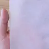 Tela no tejida en blanco y negro tela para núcleo de almohada no tejida tela a prueba de polvo proyecto de plántulas tela de embalaje no tejida